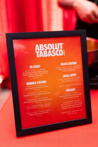 Framed red Absolut Tabasco menu with sections like To Start and Brunch Station