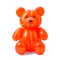 Bright orange plastic teddy bear toy facing the camera, sitting with arms relaxed.