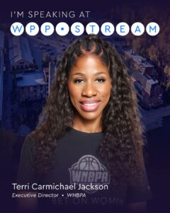 Portrait of a smiling woman in a dark shirt against a cityscape backdrop, promoting a speaking engagement.