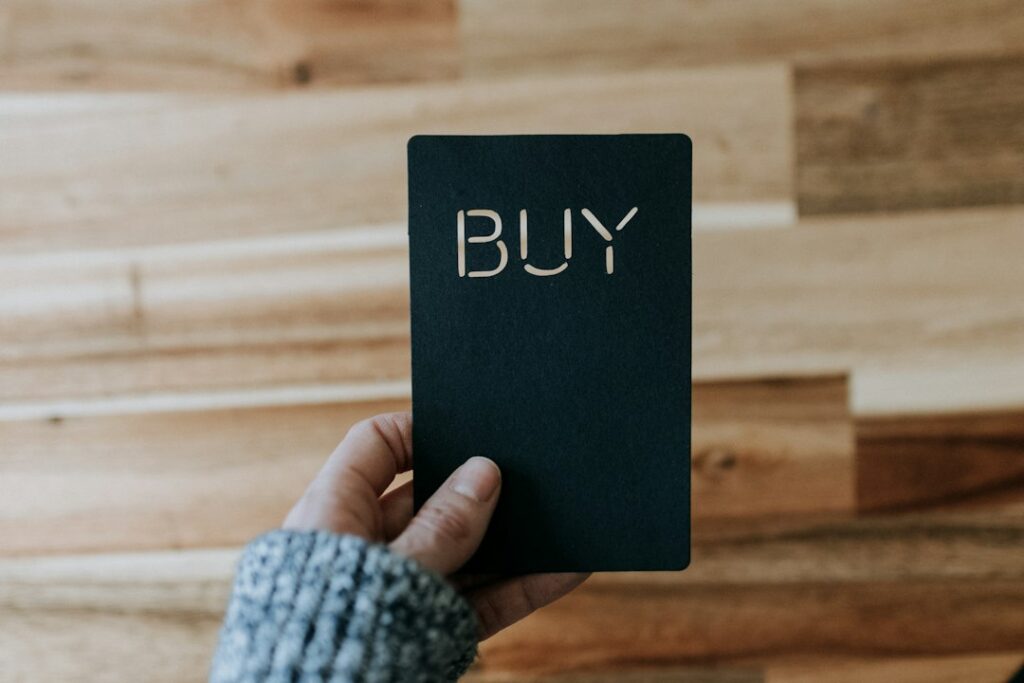 Photo by Kelly Sikkema Canadian Ad Insider a person holding a black book with the word buy written on it